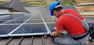 Technician installing solar panels.