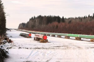 A long row of pipeline being pieced together.