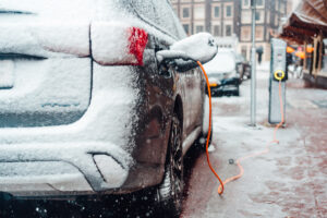 Electric car plug charging in the winter. Amsterdam, Netherlands