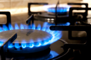 Black gas stove and two burning flames close-up