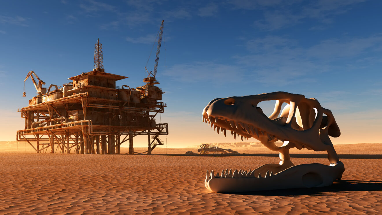 Dinosaur skeleton and the oil station in the desert - photo concept