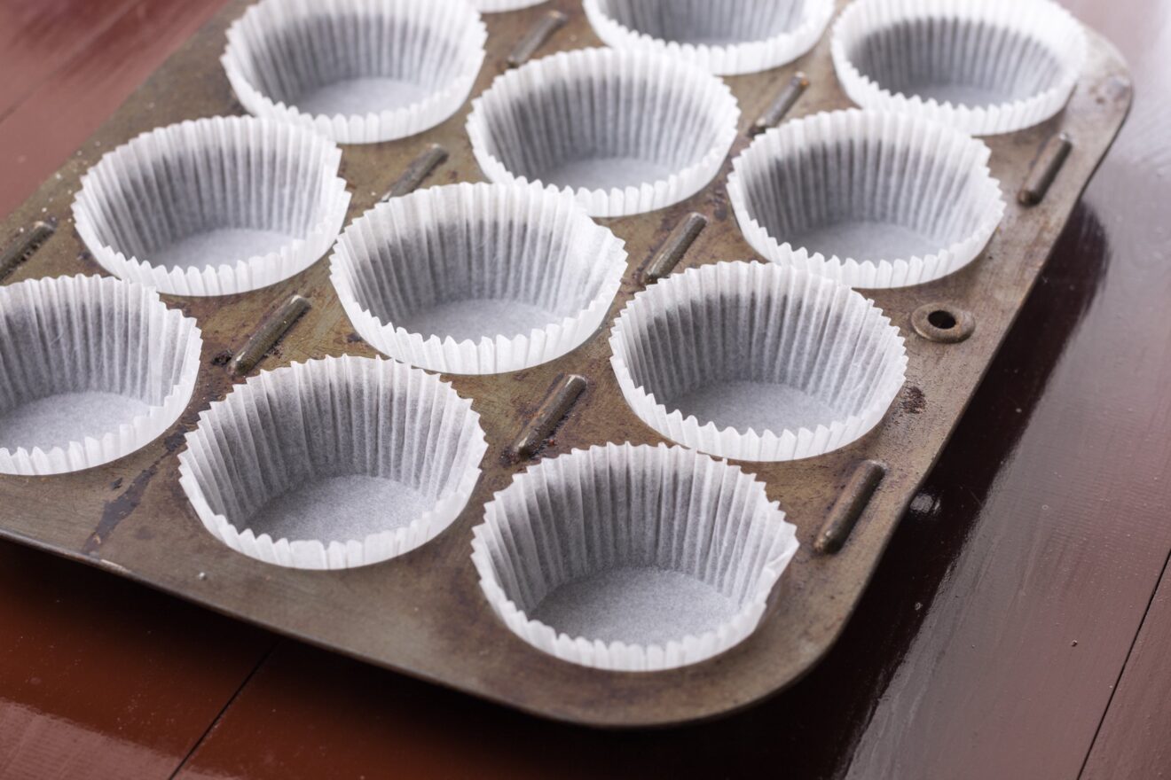 Empty white cup cakes papers ready for baking