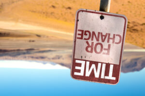 Upside down Time for Change sign on a desert
