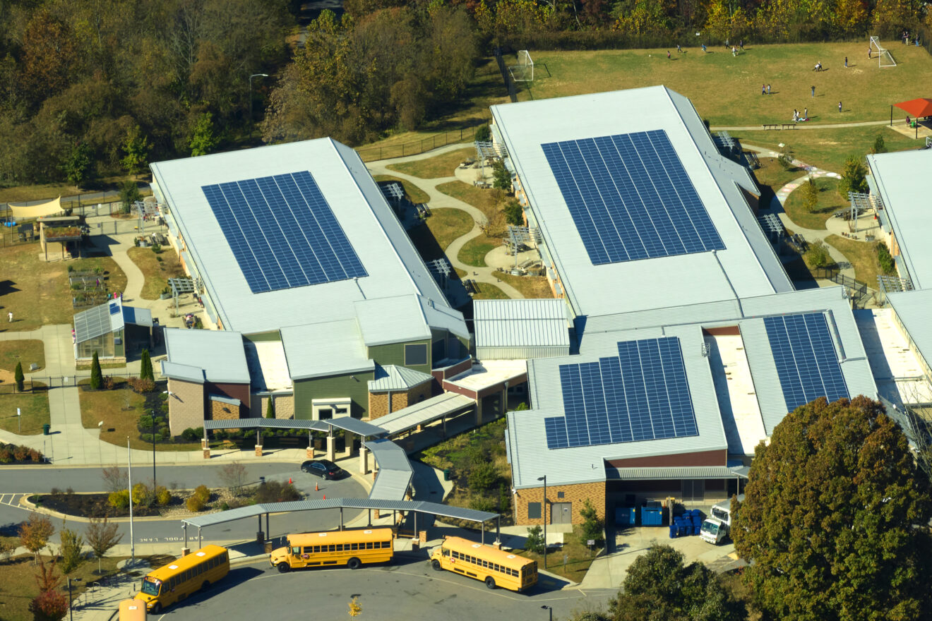 Roof of american school building covered with photovoltaic solar panels for production of electric energy.