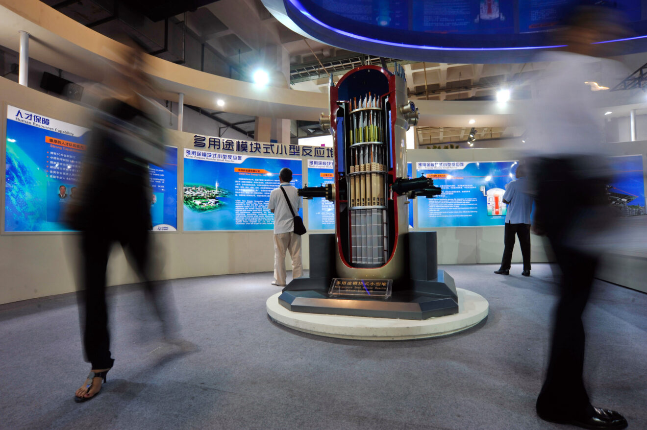 Visitors walk past a model of a multi-purpose small modular reactor on display at the stand of CNNC (China National Nuclear Corporation) during the 15th China Beijing International High-Tech Expo in Beijing, China, 25 May 2012.