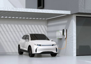 White electric powered SUV recharging in garage
